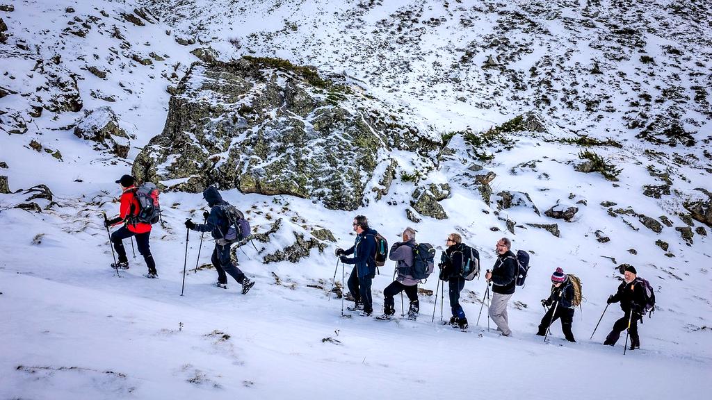 Group of hikers on a mountain ridge at sunrise