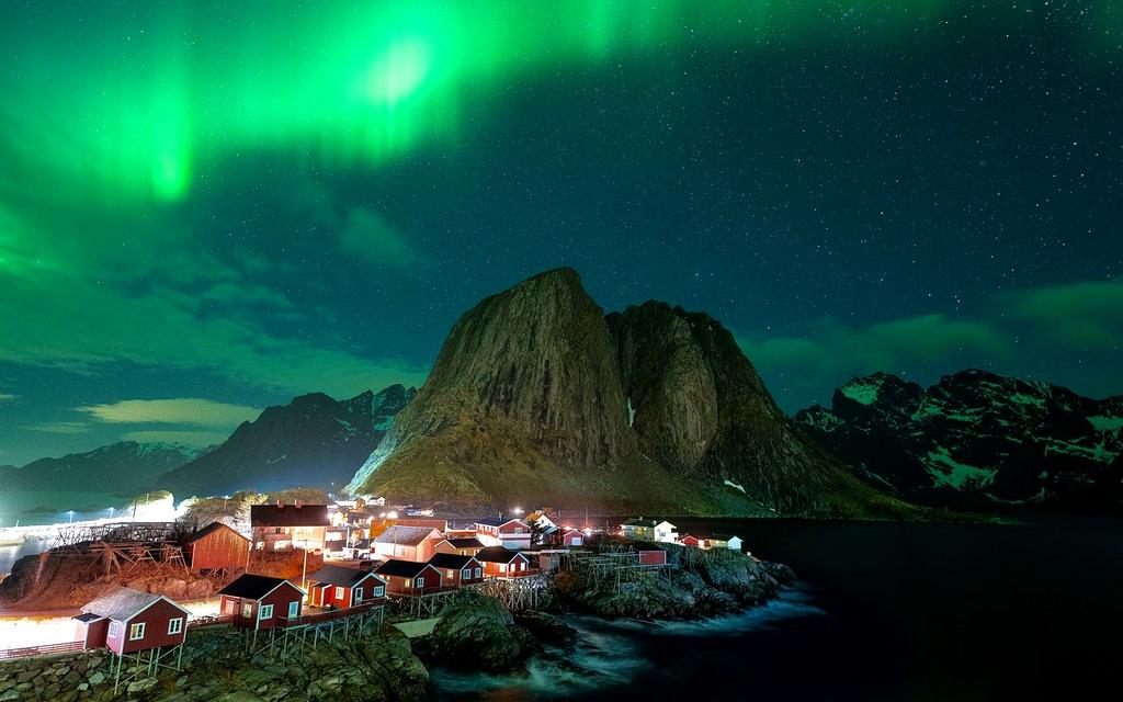 Northern lights reflecting over a frozen lake