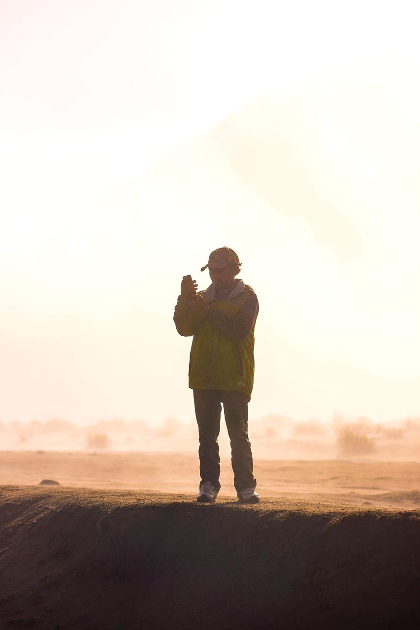 Smiling guide helping hikers on a trail