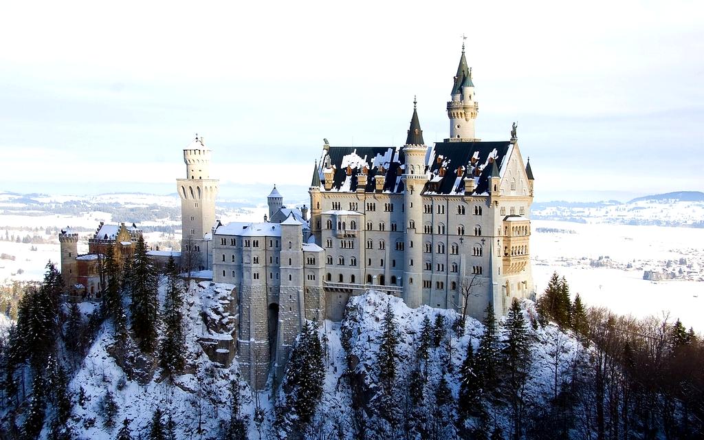 Group doing yoga outdoors on a hilltop at sunrise