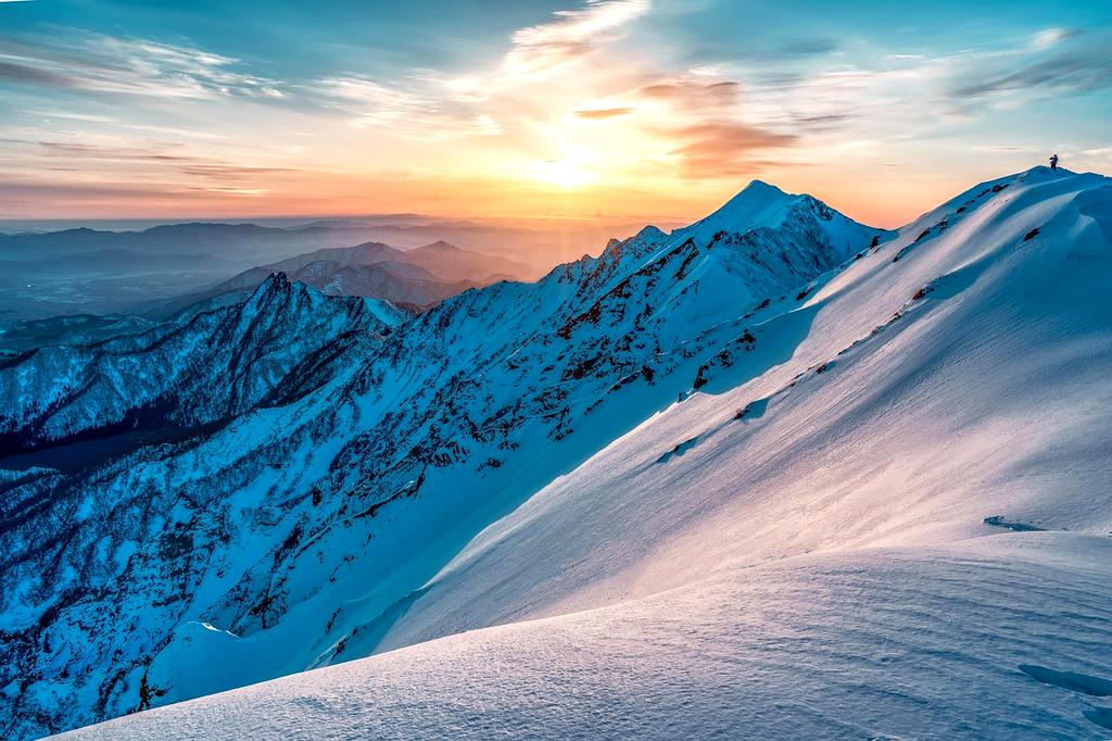 Adventure team in mountain landscape at sunrise